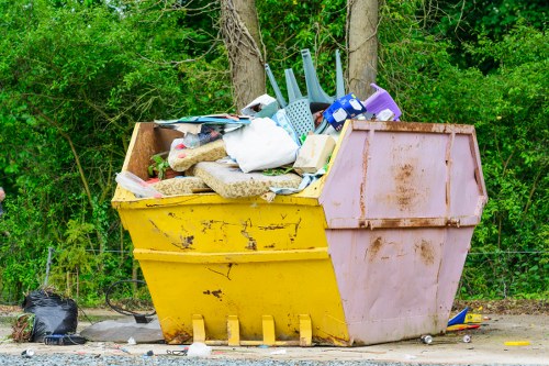 Skip truck delivering waste in East Ham