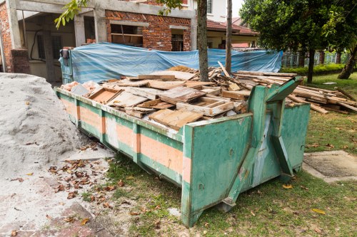 Construction site with waste disposal containers in East Ham